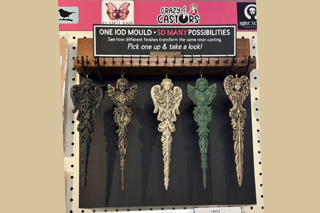 Angel ornaments hanging on cup hook shelf rack with sign
